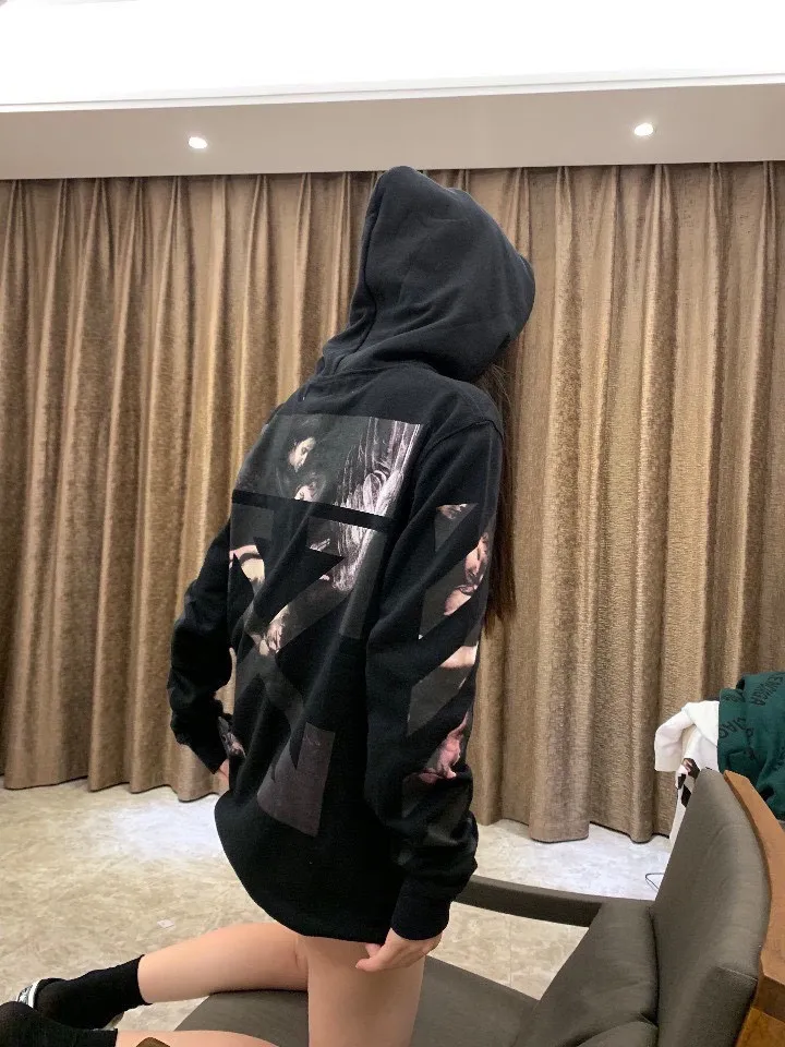 ♻️💯Reference model picture for the upper body❤️ Top tested version OFF WHITE OW Certified Angel Wings Madonna religious oil painting men's and women's round neck zipper cardigan sweatshirt. The A mark on the collar is a 3M reflective mark, customized model, not an embroidery mark, first look at the appraisal.  The Renaissance-themed Caravaggio Madonna oil painting is inspired by one of Caravaggio's famous oil paintings, with a strong religious color! World treasures, top-notch paintings, and walking art pieces follow the original craftsmanship and use 5-color glue to create an effect. It is not offset printing, but many people on the market use Kornit direct inkjet instead. Whether it is the top version, touch the printing with your hand. The correct process is that it has a frosted feel. This is also a way to identify the uniqueness of the product. The fabric is 100% combed cotton terry fabric, 480 grams, ensuring the originality of the craftsmanship! Secondly, the tag rope of this model hangs from the collar tag, not the side rope. Customized auxiliary materials, complete accessories, consistent zp, hang tags, collar labels, and washed labels, feel free to compare!   Color: Black White Size Chart